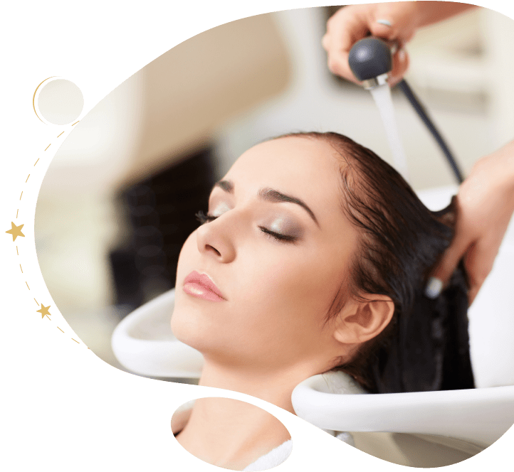 Woman receiving hair wash at salon.